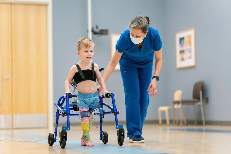 A child using an assistive walking device