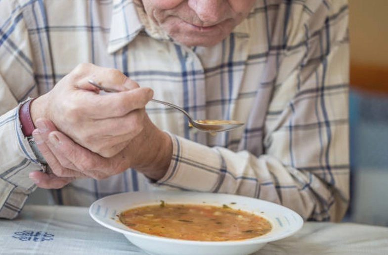 A neurologist examining a patient's hand tremor